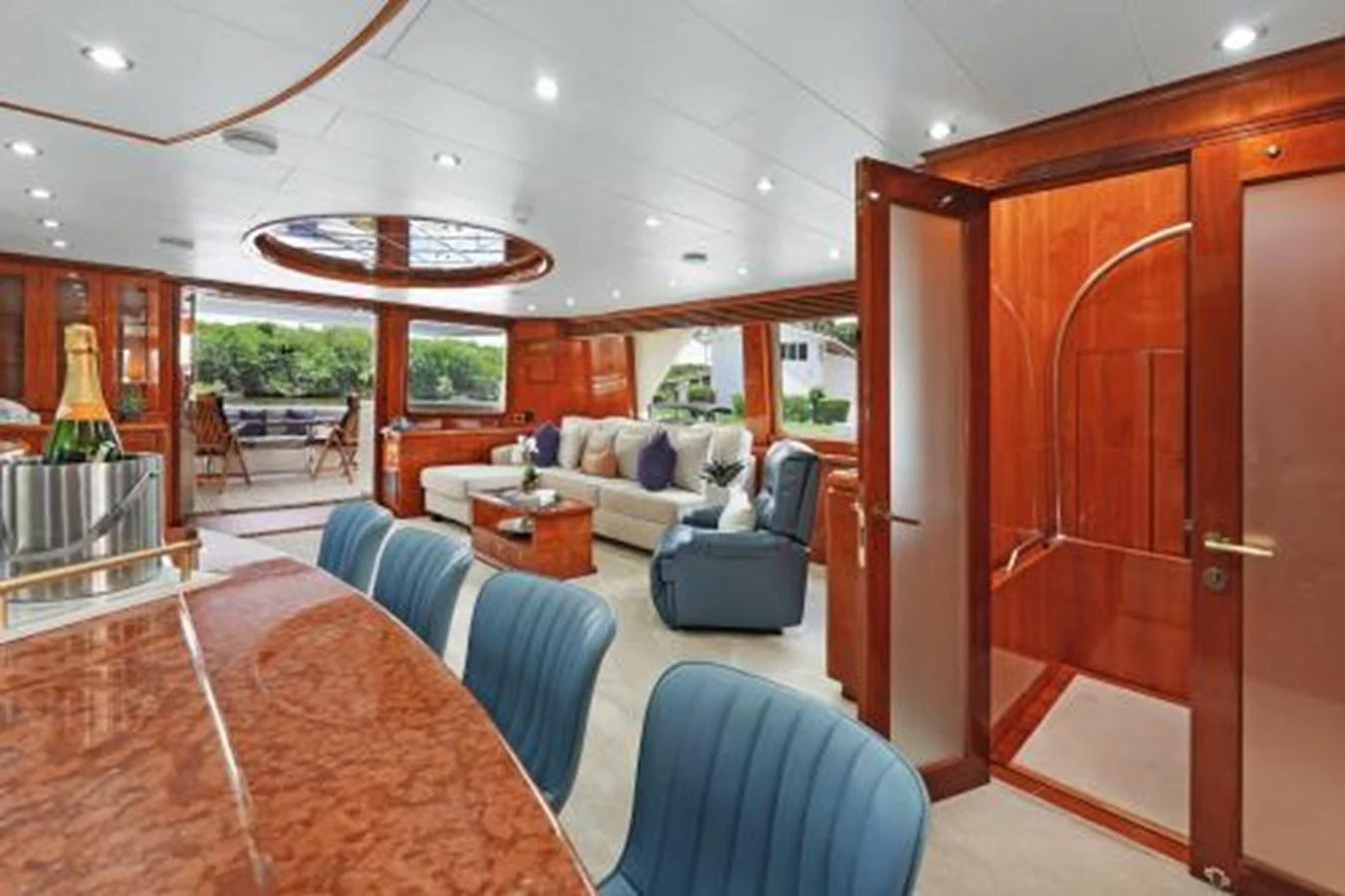 The spacious salon features luxurious seating, elegant wood finishes, and ample natural light. aboard SUE CAROLYN Yacht for Sale