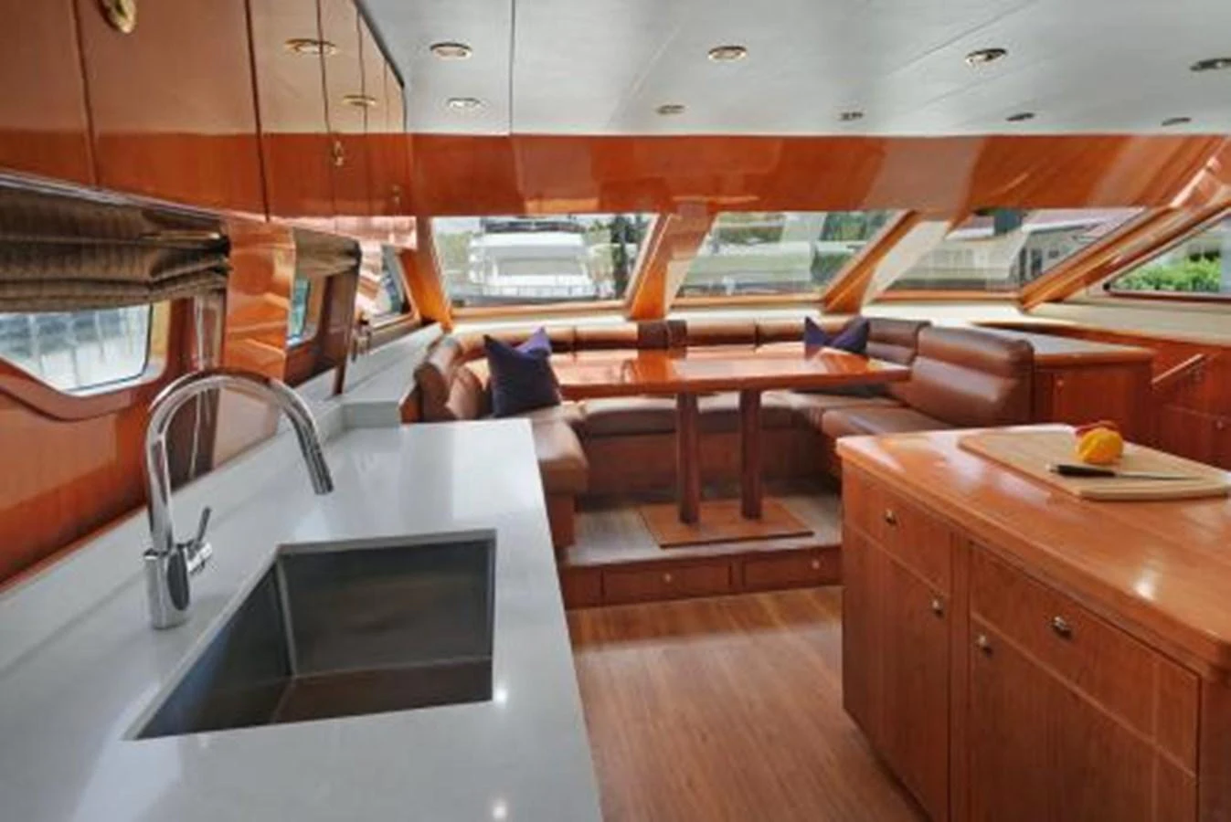 The yacht's galley features a sleek countertop, modern sink, and a cozy dining area with large windows offering scenic views. aboard SUE CAROLYN Yacht for Sale