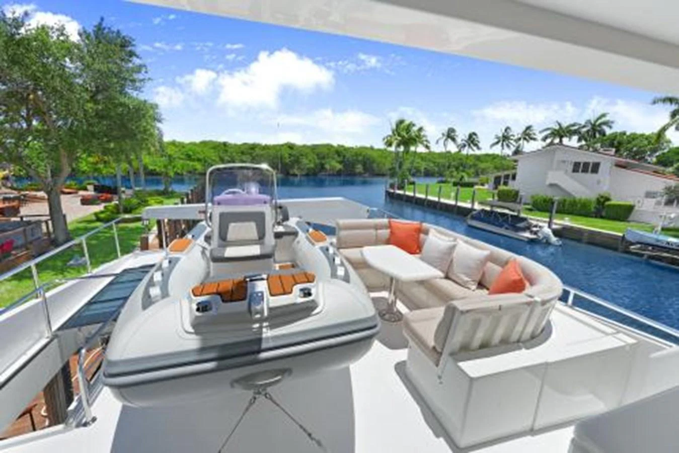 The aft deck features a comfortable seating area and a tender, perfect for relaxation and easy access to the water. aboard SUE CAROLYN Yacht for Sale