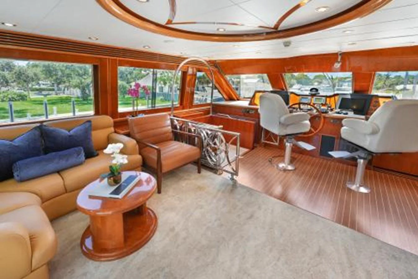 The helm area features luxurious seating and a spacious, well-lit environment with large windows offering scenic views. aboard SUE CAROLYN Yacht for Sale