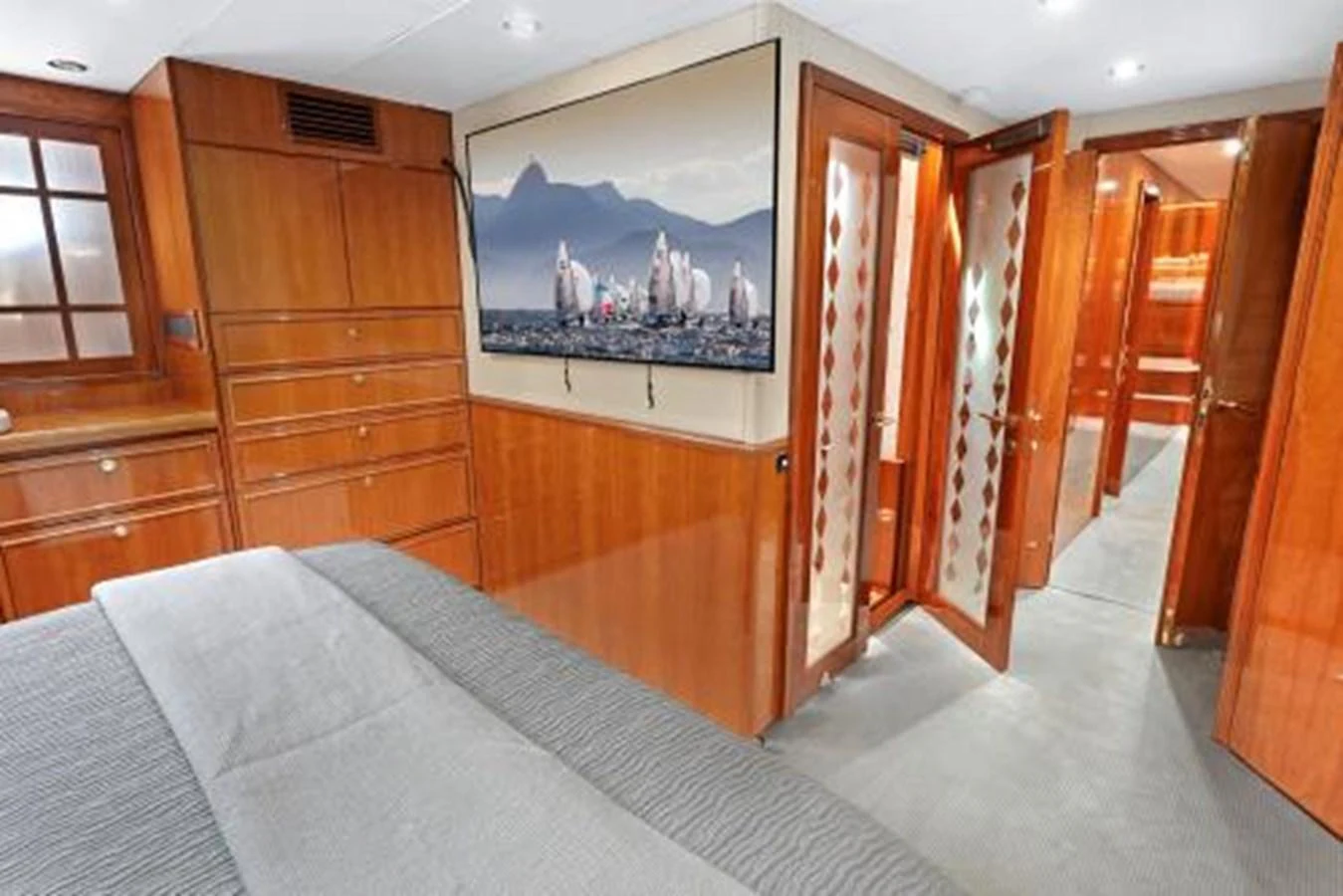 The stateroom features elegant wood paneling and a large flat-screen TV. aboard SUE CAROLYN Yacht for Sale