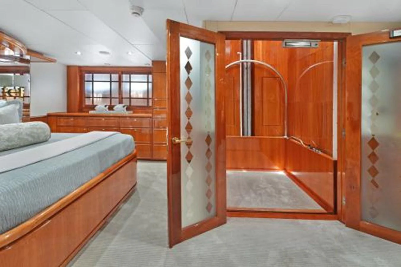 The master stateroom features luxurious wood finishes and a spacious layout with an en-suite bathroom. aboard SUE CAROLYN Yacht for Sale