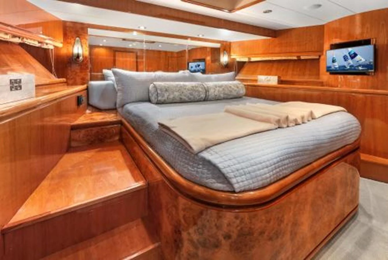 The stateroom features a luxurious bed with plush bedding and elegant wooden finishes. aboard SUE CAROLYN Yacht for Sale