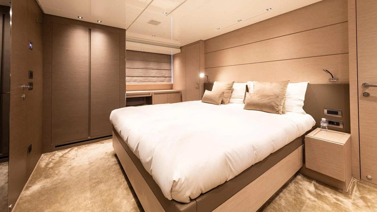 The master stateroom features a plush bed with elegant bedding and modern furnishings. aboard REGINE OF CANNES Yacht for Sale