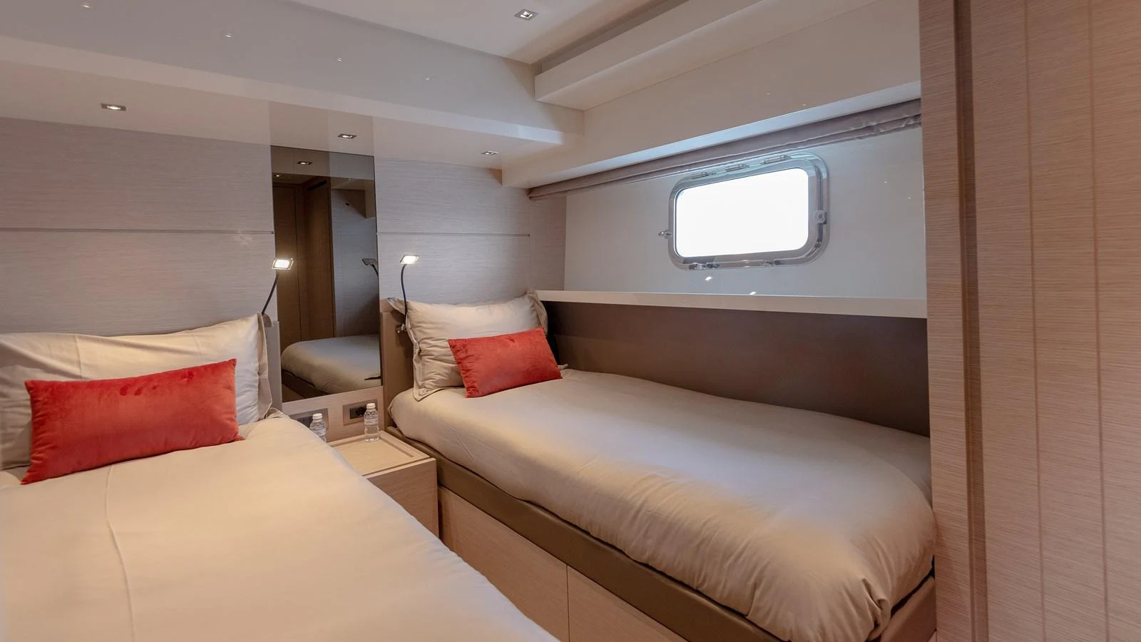 The guest stateroom features twin beds with plush bedding and a large window for natural light. aboard REGINE OF CANNES Yacht for Sale