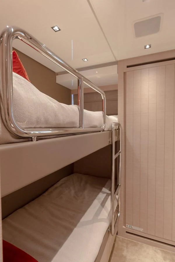 The cozy bunk room features modern lighting and comfortable bedding. aboard REGINE OF CANNES Yacht for Sale
