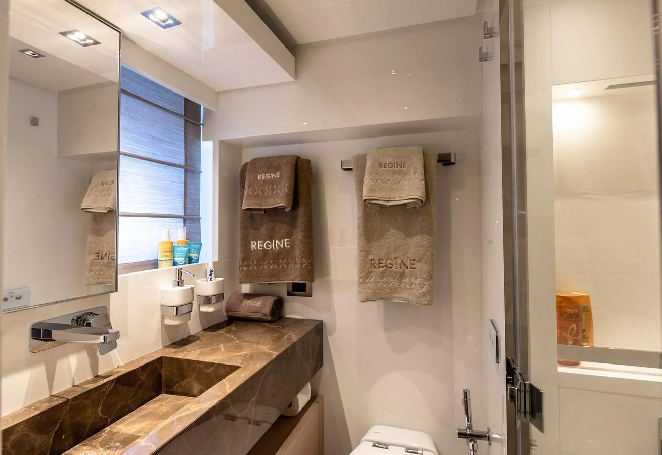 The yacht's bathroom features a sleek design with modern fixtures and luxurious amenities. aboard REGINE OF CANNES Yacht for Sale