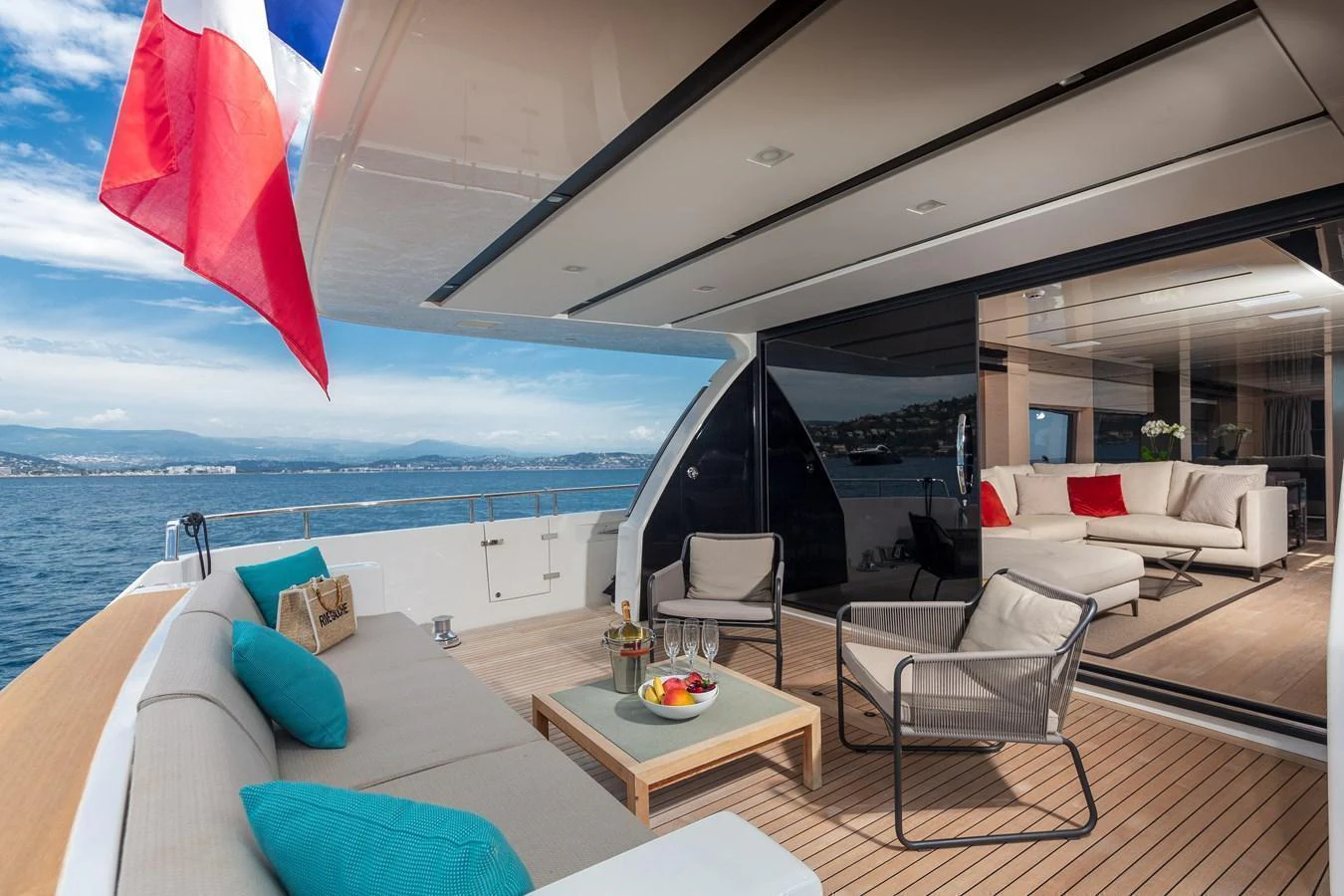 The aft deck features a comfortable seating area with a stunning view of the sea. aboard REGINE OF CANNES Yacht for Sale
