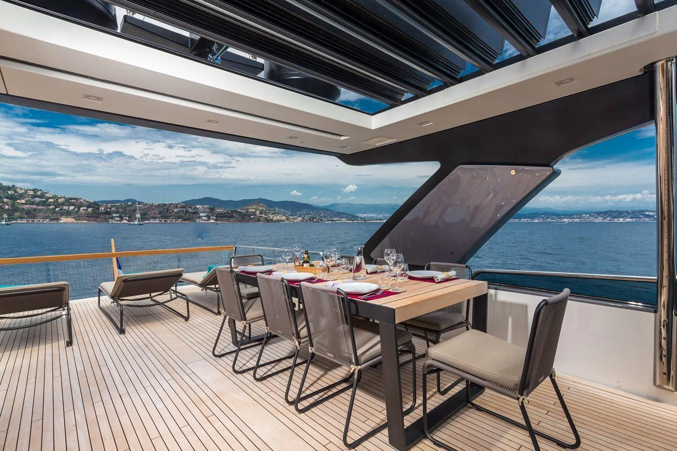 The aft deck features an elegant dining area with panoramic ocean views. aboard REGINE OF CANNES Yacht for Sale