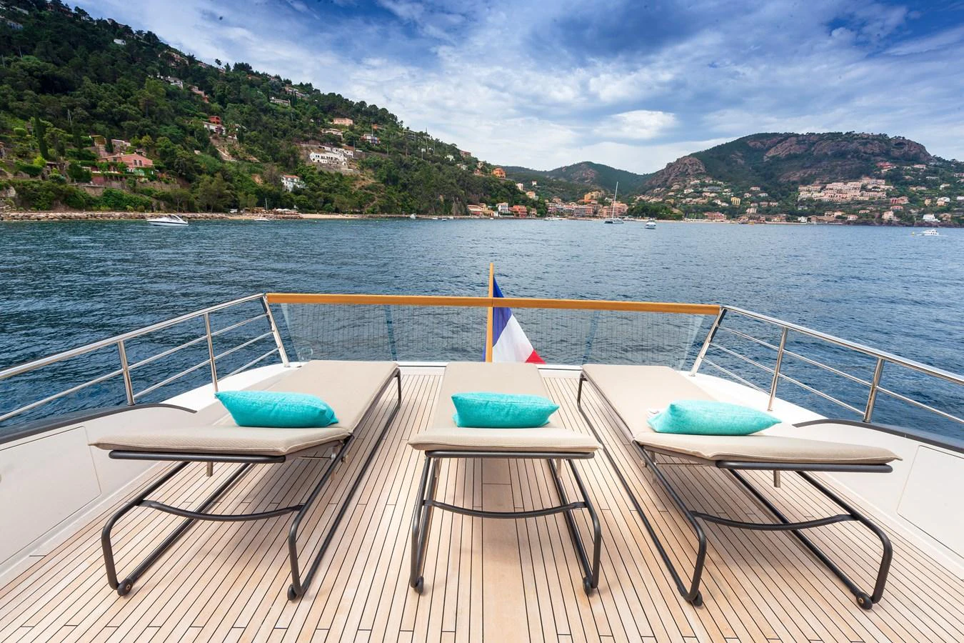 The aft deck features luxurious sun loungers with a stunning view of the coastline. aboard REGINE OF CANNES Yacht for Sale