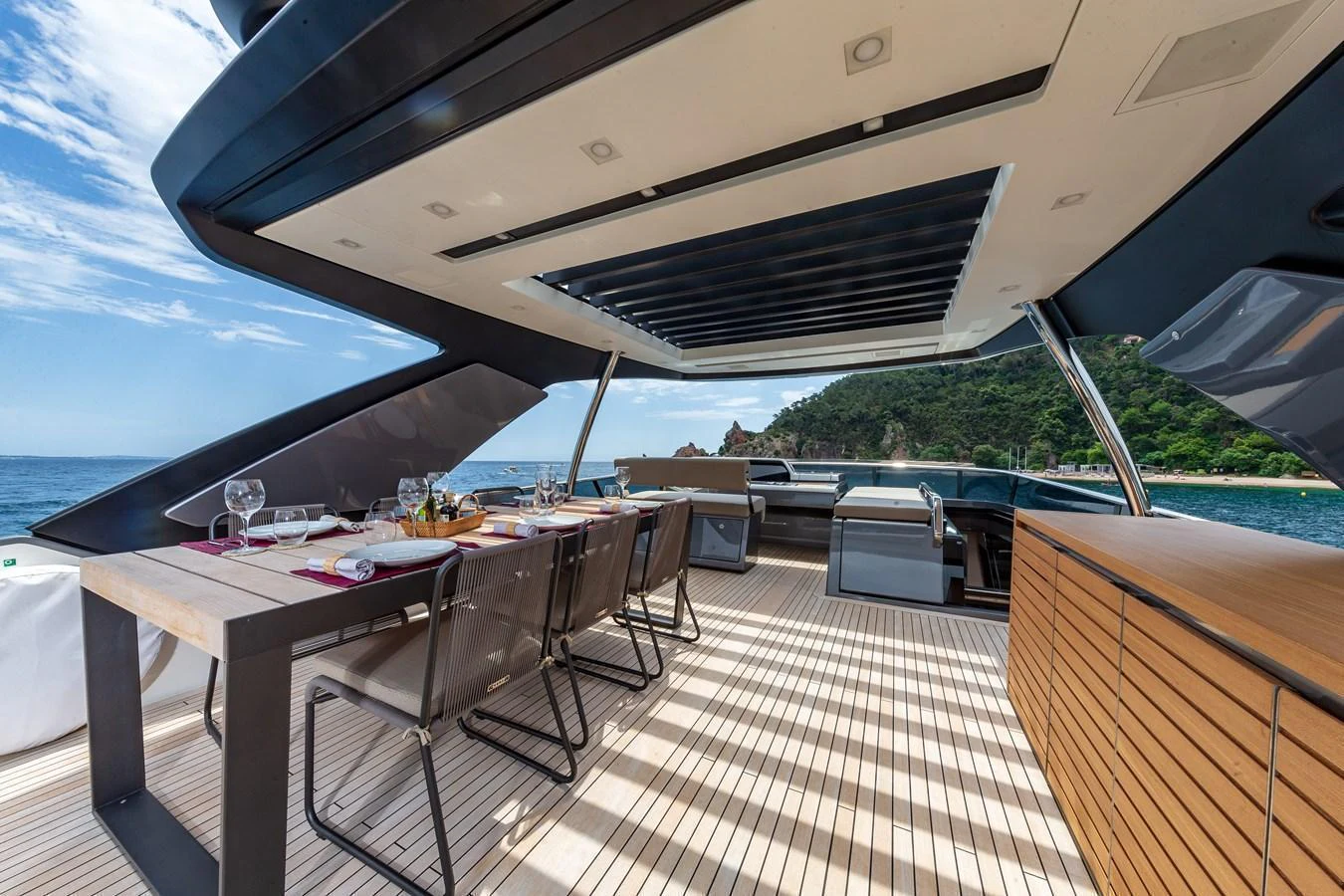The aft deck features an elegant dining area with stunning ocean views. aboard REGINE OF CANNES Yacht for Sale