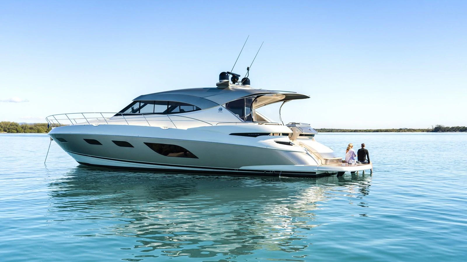 a couple of people sitting on a boat in the water aboard 6800 SPORT YACHT Yacht for Sale