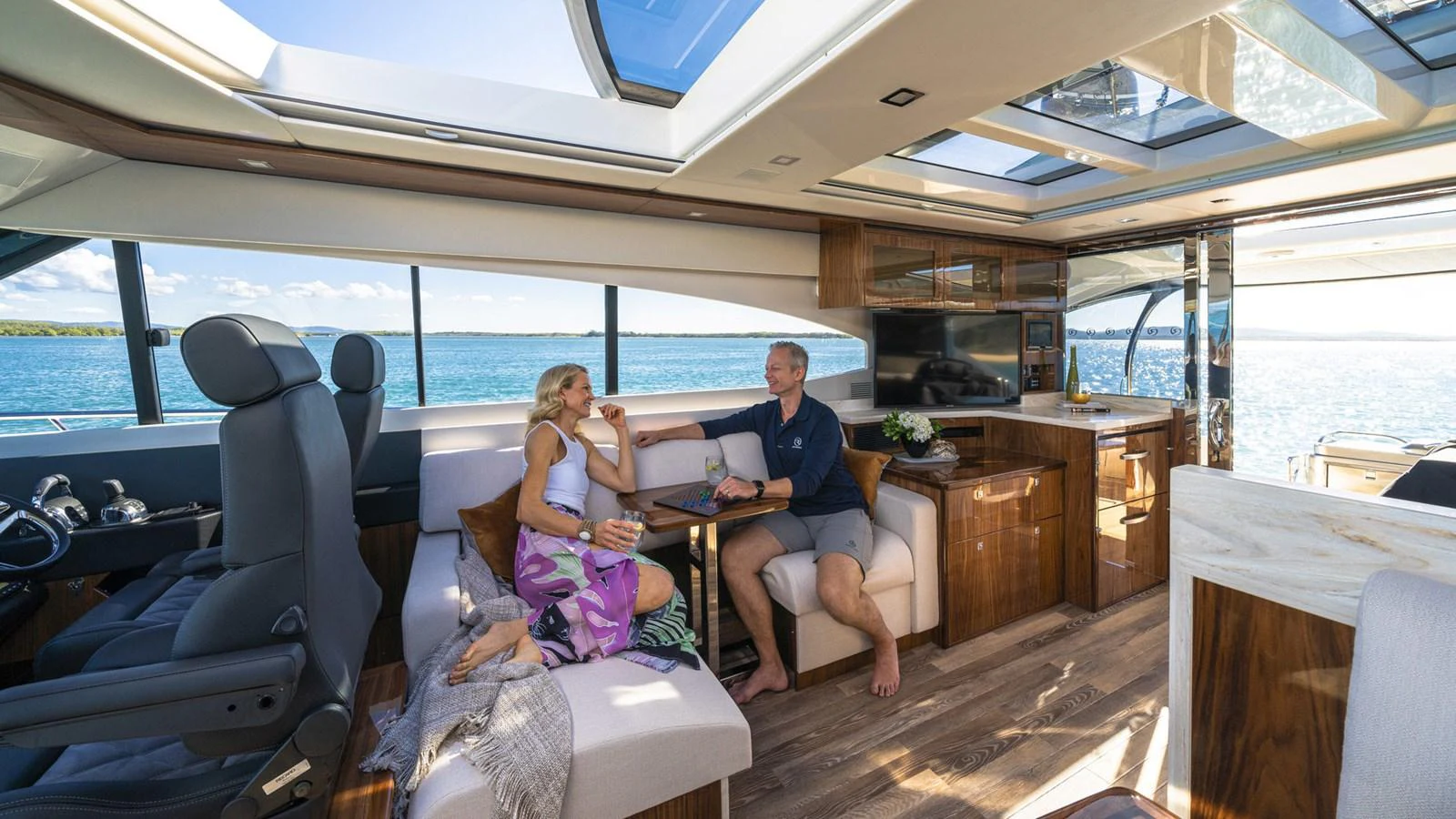 a man and woman sitting at a table in a boat aboard 6800 SPORT YACHT Yacht for Sale