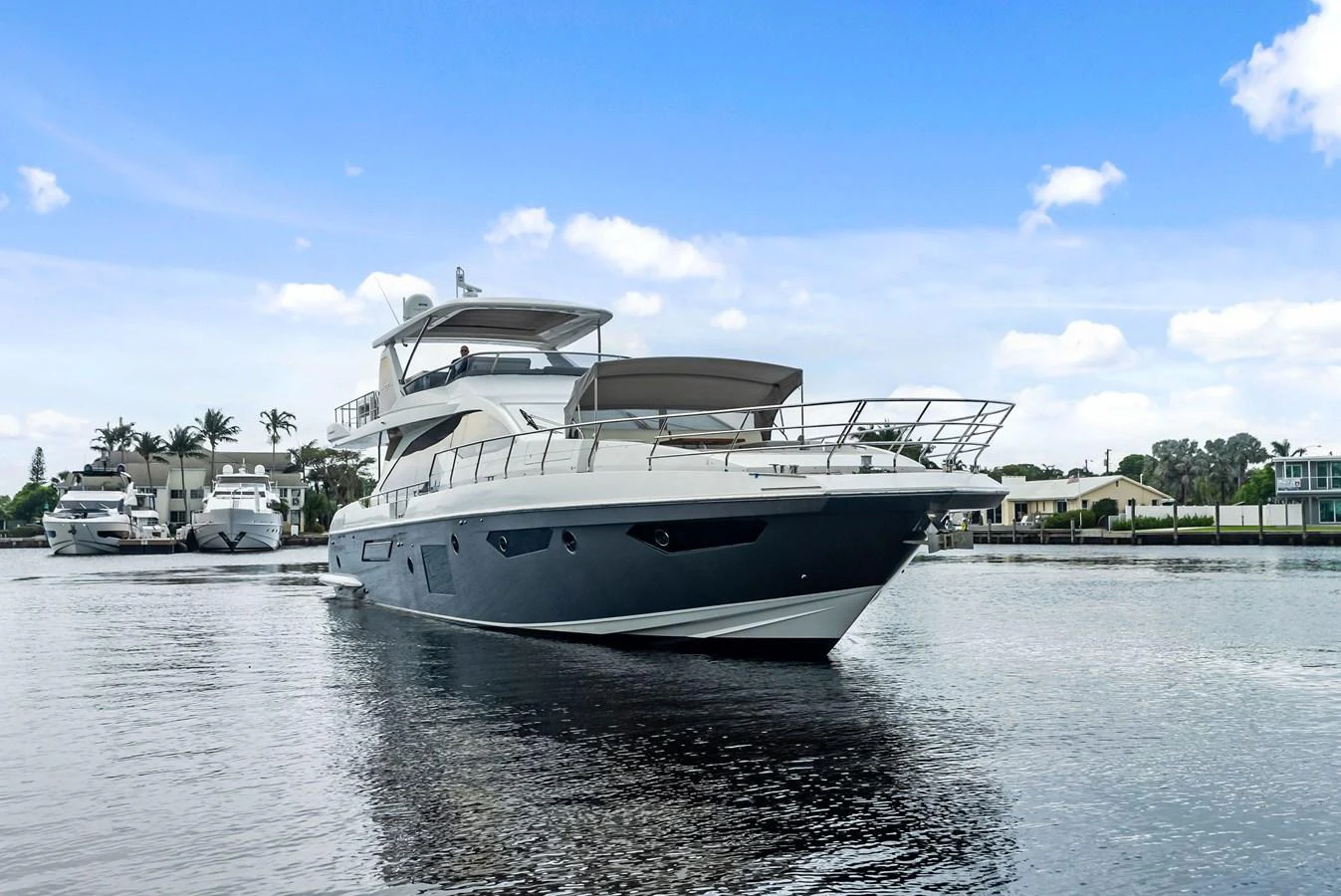 A sleek and modern yacht glides gracefully on calm waters, showcasing its elegant design. aboard CLASS DISMISSED Yacht for Sale