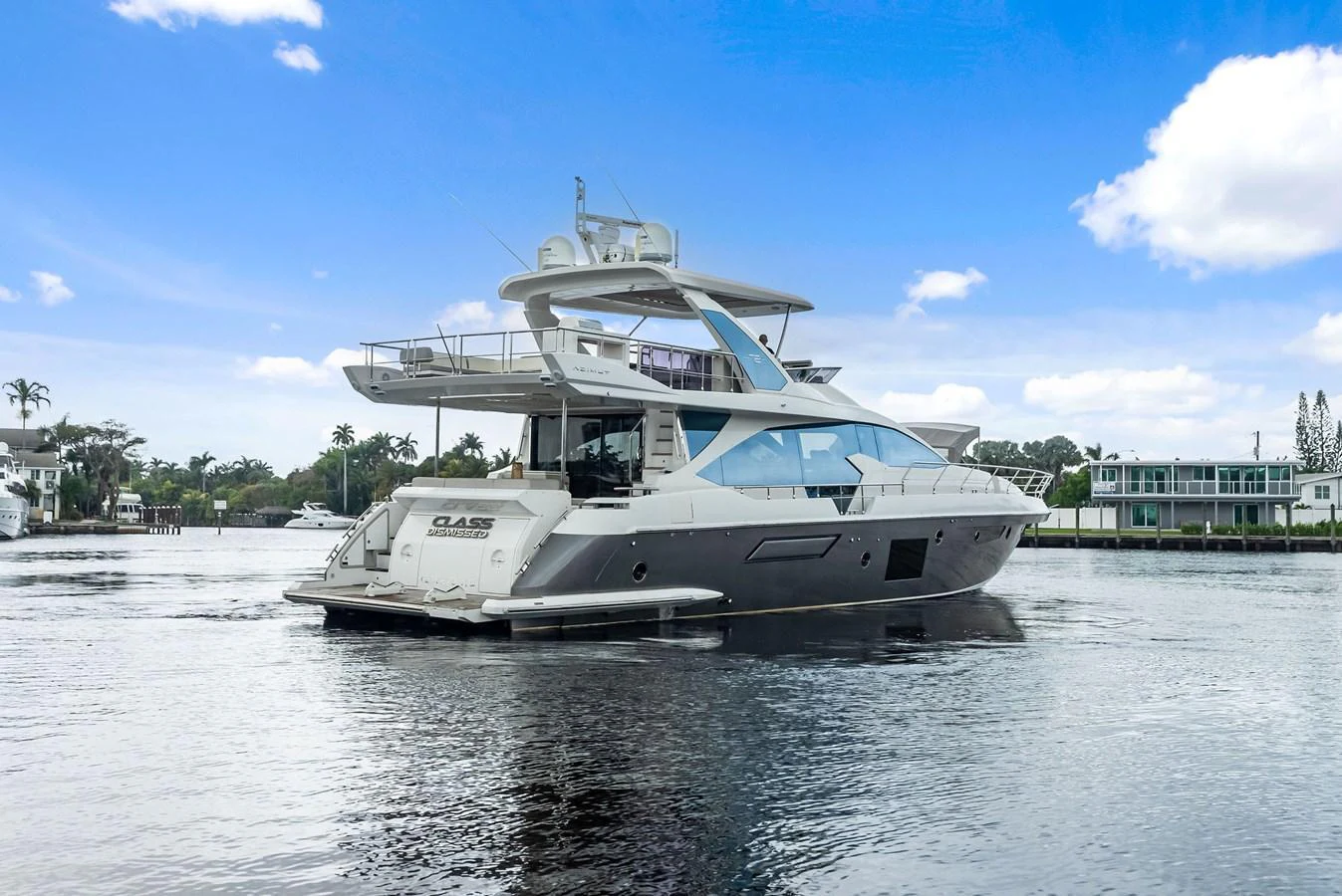 A sleek and modern yacht glides gracefully on calm waters, showcasing its elegant design and spacious decks. aboard CLASS DISMISSED Yacht for Sale