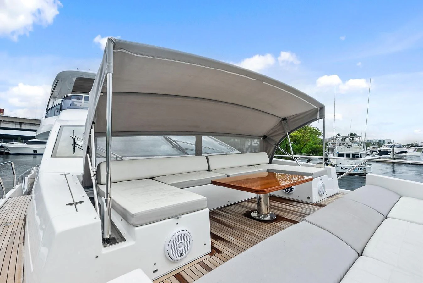 The flybridge offers a spacious seating area with a retractable canopy for shade and comfort. aboard CLASS DISMISSED Yacht for Sale