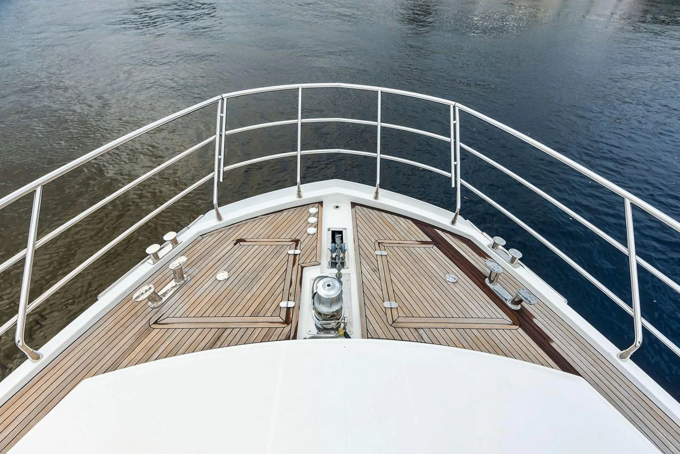 The bow of the yacht features a sleek design with polished wood decking and stainless steel railings. aboard CLASS DISMISSED Yacht for Sale