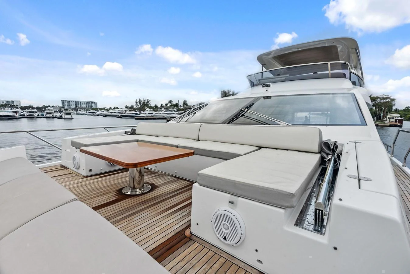 The aft deck features a spacious seating area with a wooden table, perfect for outdoor relaxation and dining. aboard CLASS DISMISSED Yacht for Sale