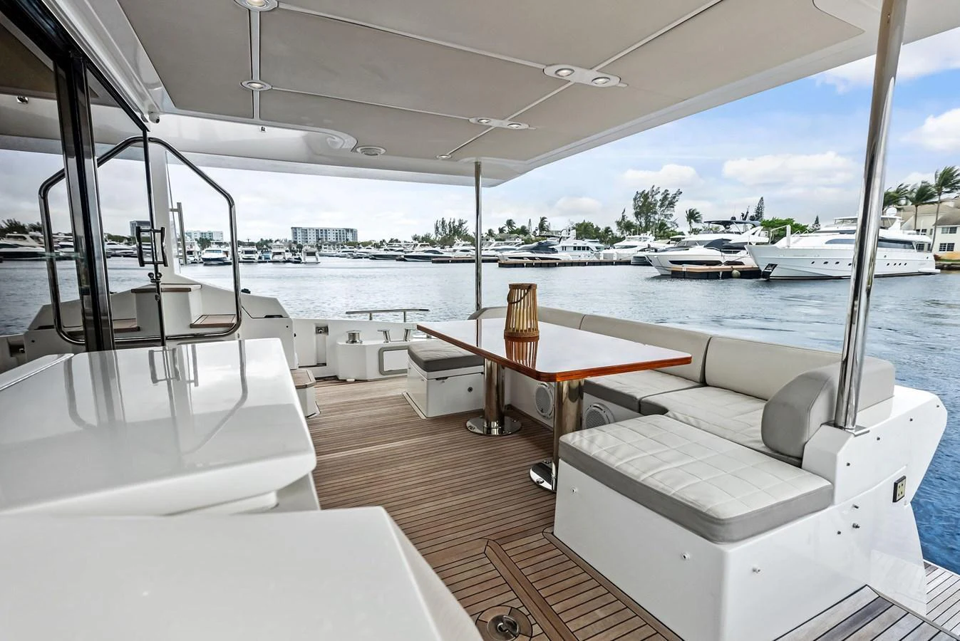 The aft deck offers a spacious and comfortable seating area with a view of the marina. aboard CLASS DISMISSED Yacht for Sale