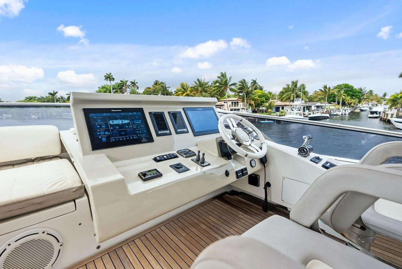 The helm station offers a modern and well-equipped control area with a scenic view of the marina. aboard CLASS DISMISSED Yacht for Sale