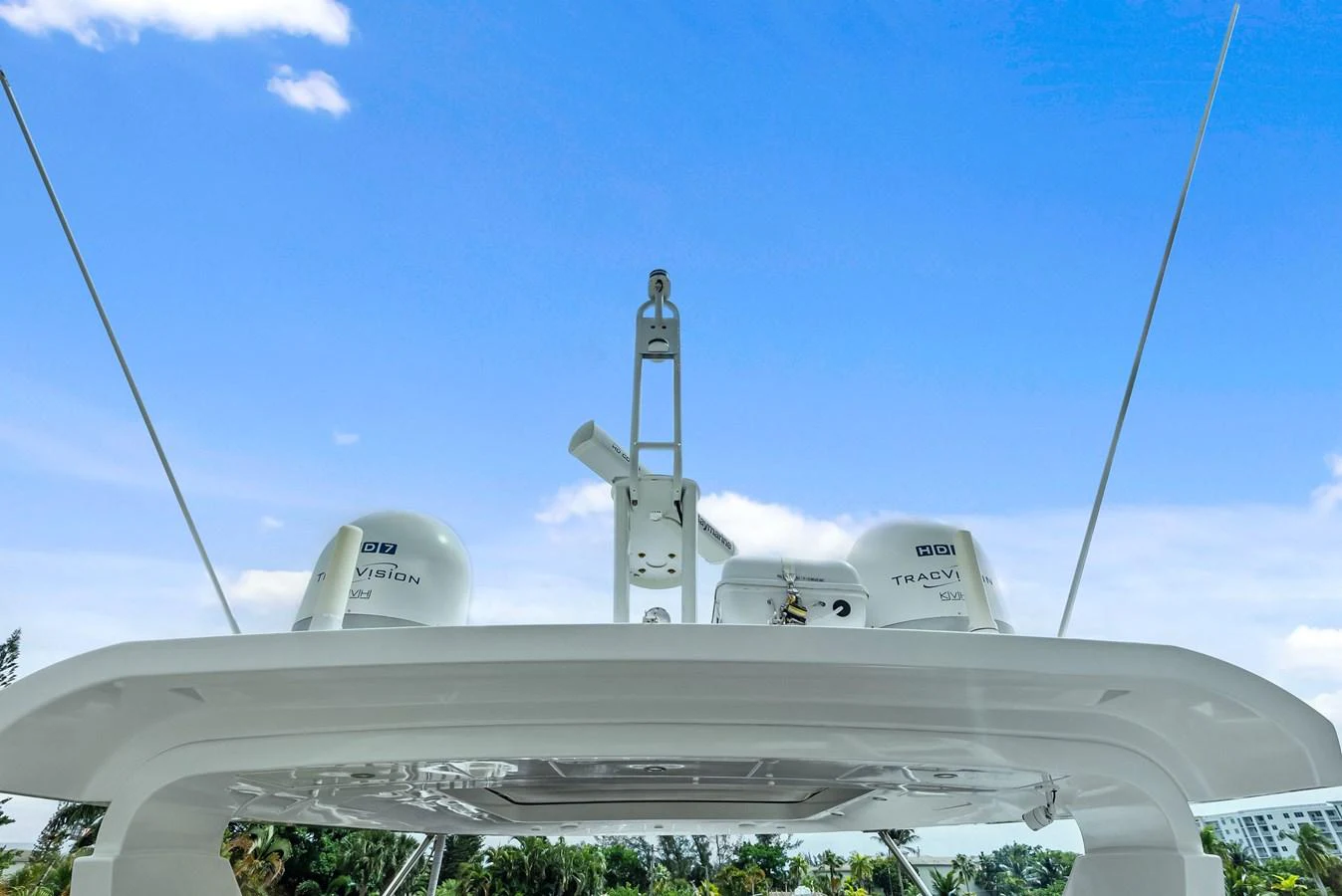 A close-up view of the yacht's radar and communication equipment against a clear blue sky. aboard CLASS DISMISSED Yacht for Sale