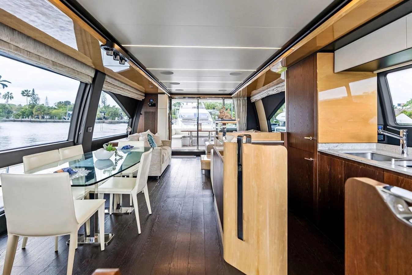 The yacht's salon features a spacious and elegant dining area with large windows offering scenic views. aboard CLASS DISMISSED Yacht for Sale