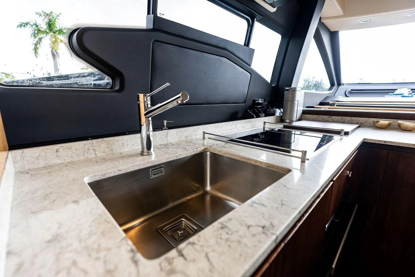 The modern galley features a sleek sink and stovetop with ample counter space. aboard CLASS DISMISSED Yacht for Sale