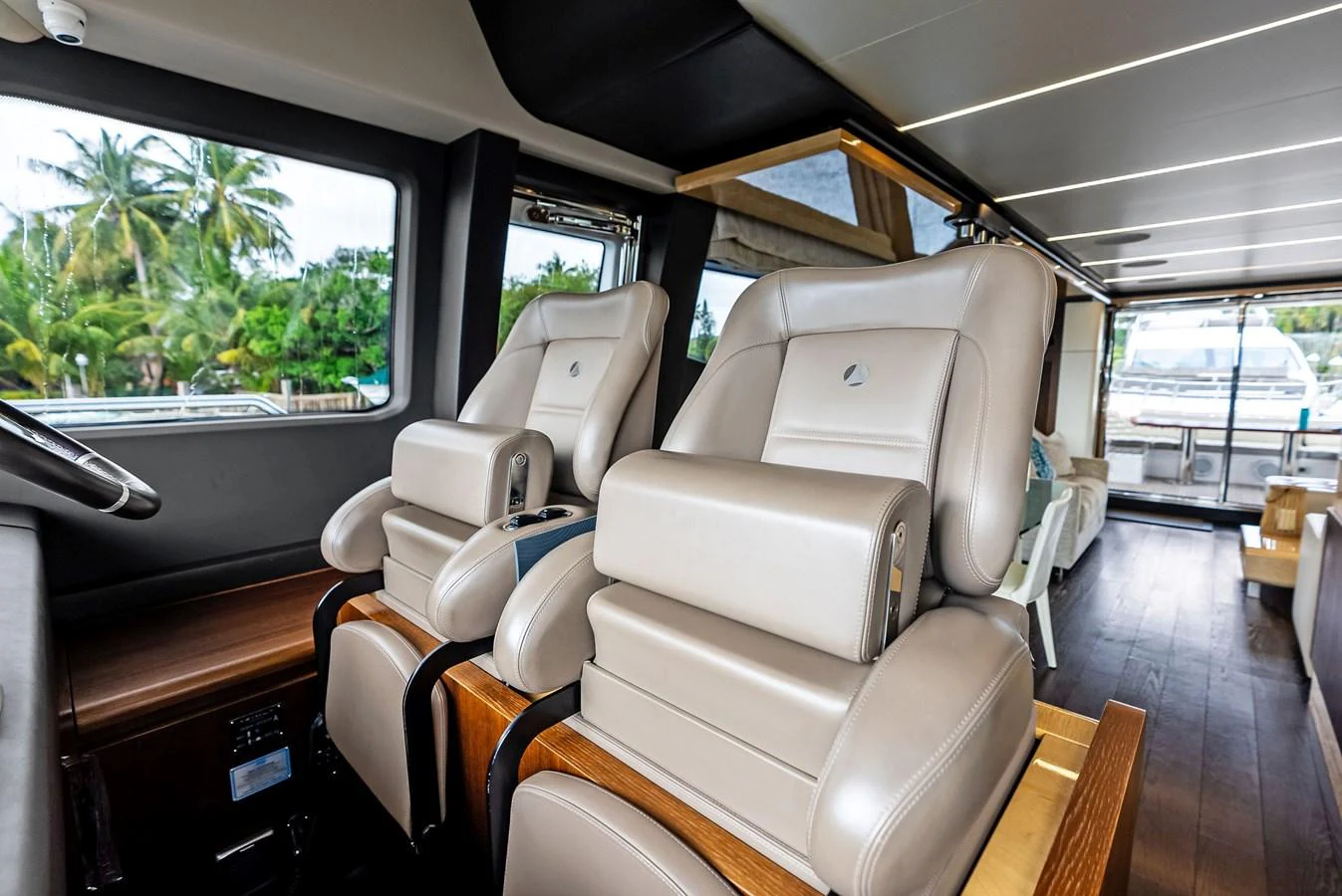 The yacht's helm features luxurious leather seating with a view of the surrounding landscape. aboard CLASS DISMISSED Yacht for Sale