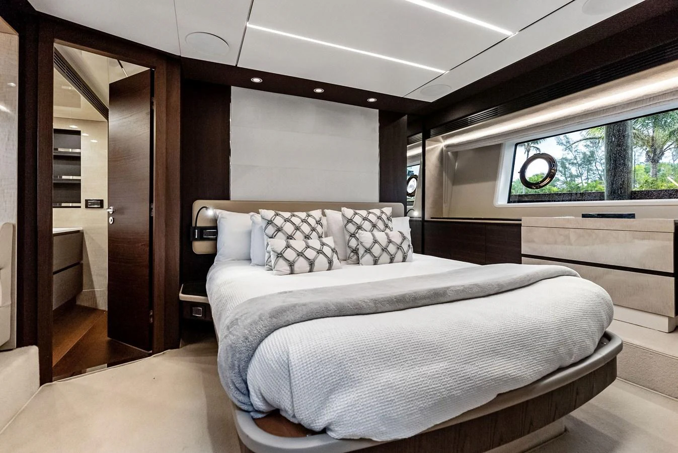 A luxurious stateroom featuring a plush bed and elegant decor. aboard CLASS DISMISSED Yacht for Sale