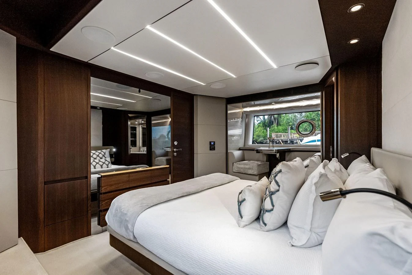 The stateroom features a luxurious bed with plush pillows and modern lighting, offering a serene retreat. aboard CLASS DISMISSED Yacht for Sale