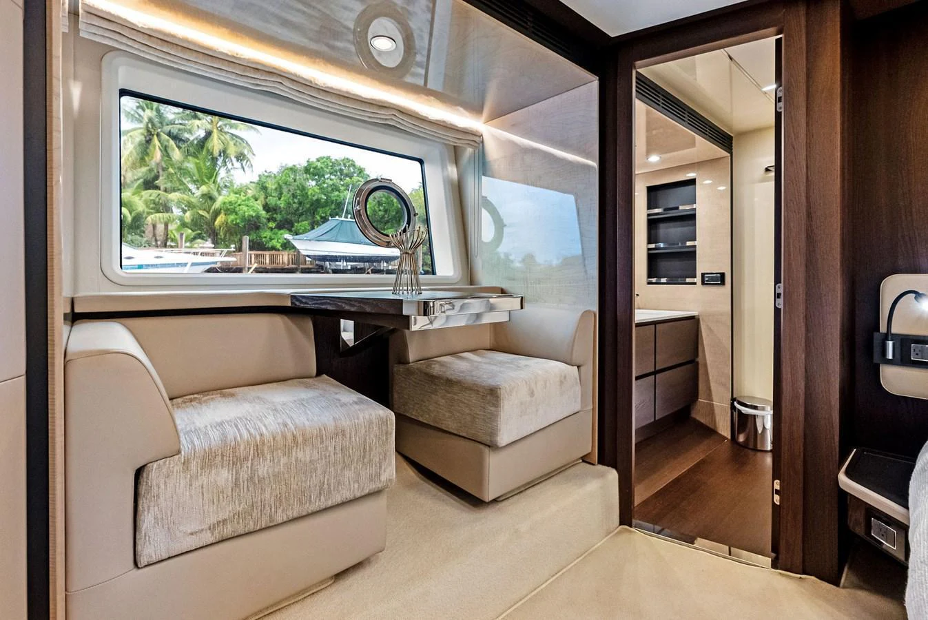 The salon features plush seating and a large window offering scenic views. aboard CLASS DISMISSED Yacht for Sale