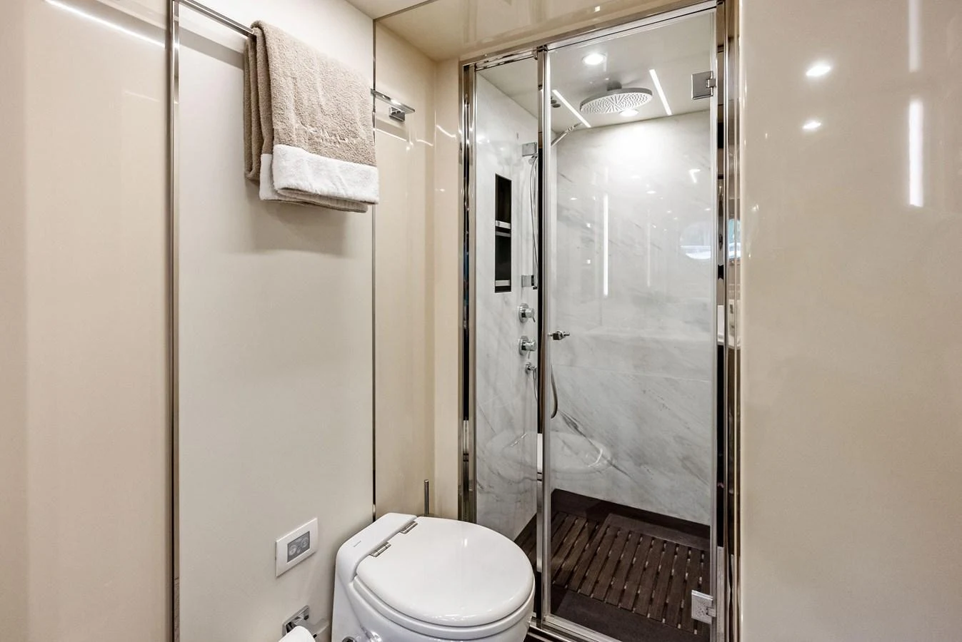 The yacht's bathroom features a modern design with a glass-enclosed shower and elegant fixtures. aboard CLASS DISMISSED Yacht for Sale
