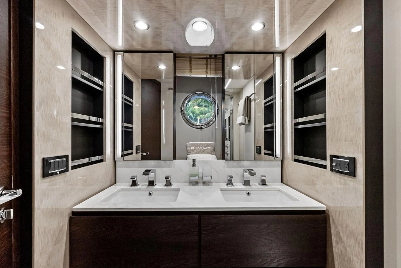 A luxurious yacht bathroom featuring a double vanity with modern fixtures and ample storage. aboard CLASS DISMISSED Yacht for Sale