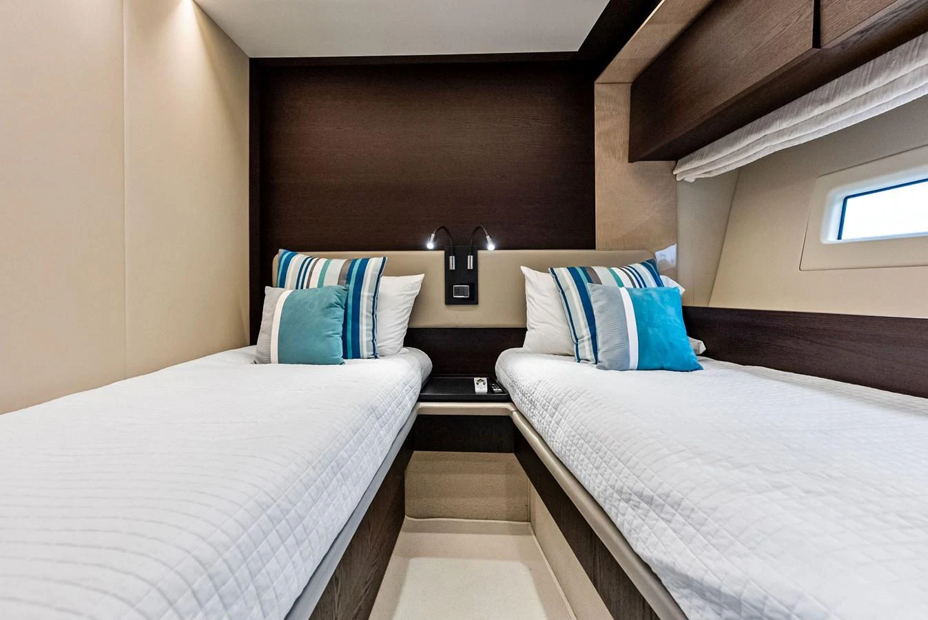 The twin stateroom offers a cozy and inviting space with two single beds and modern decor. aboard CLASS DISMISSED Yacht for Sale