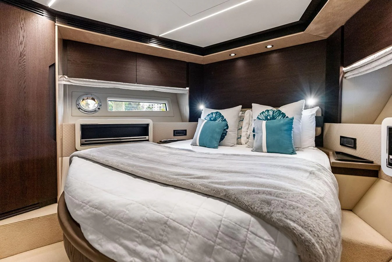 A luxurious stateroom featuring a plush bed with elegant pillows and ambient lighting. aboard CLASS DISMISSED Yacht for Sale