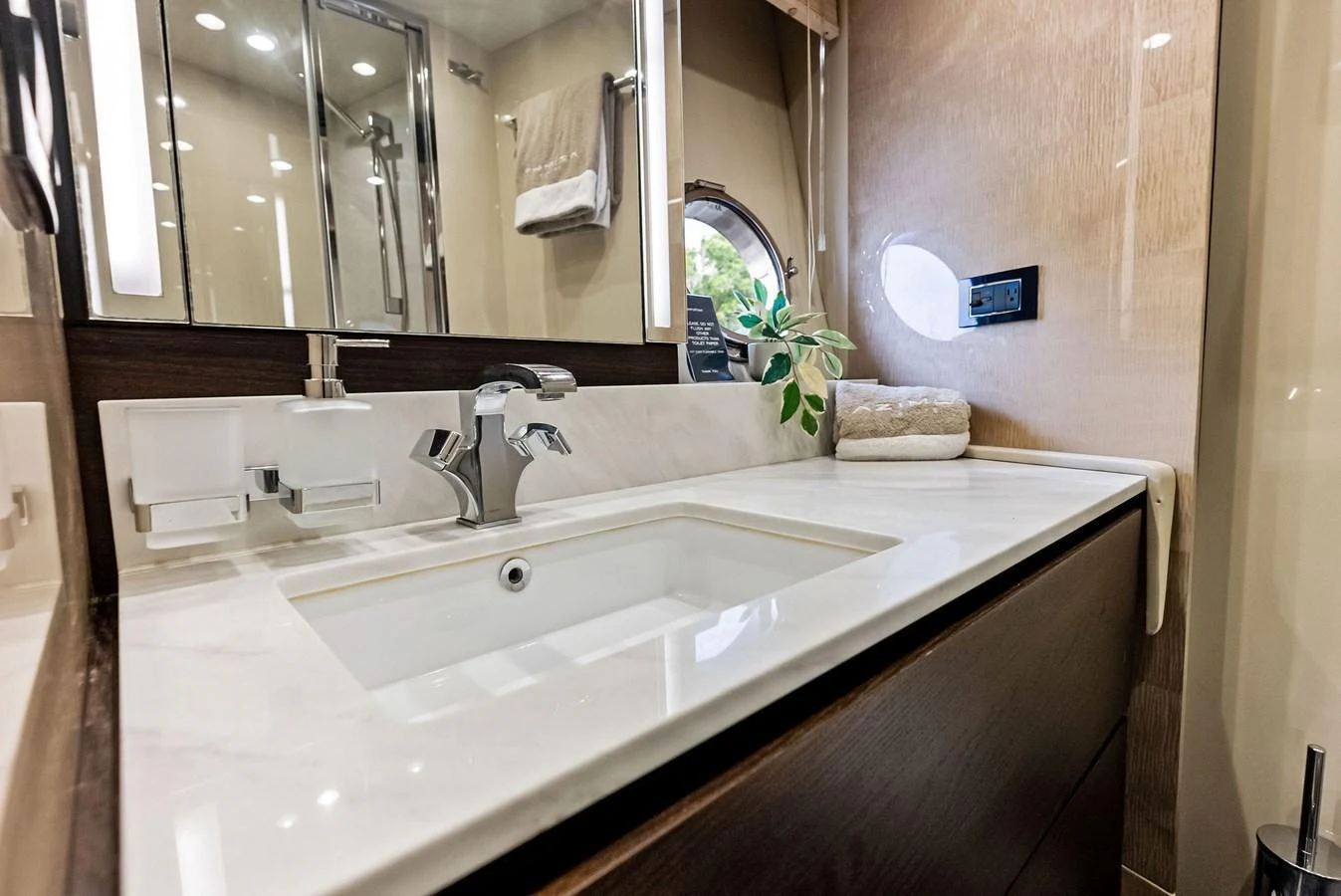 A luxurious yacht bathroom featuring a sleek sink and modern fixtures. aboard CLASS DISMISSED Yacht for Sale