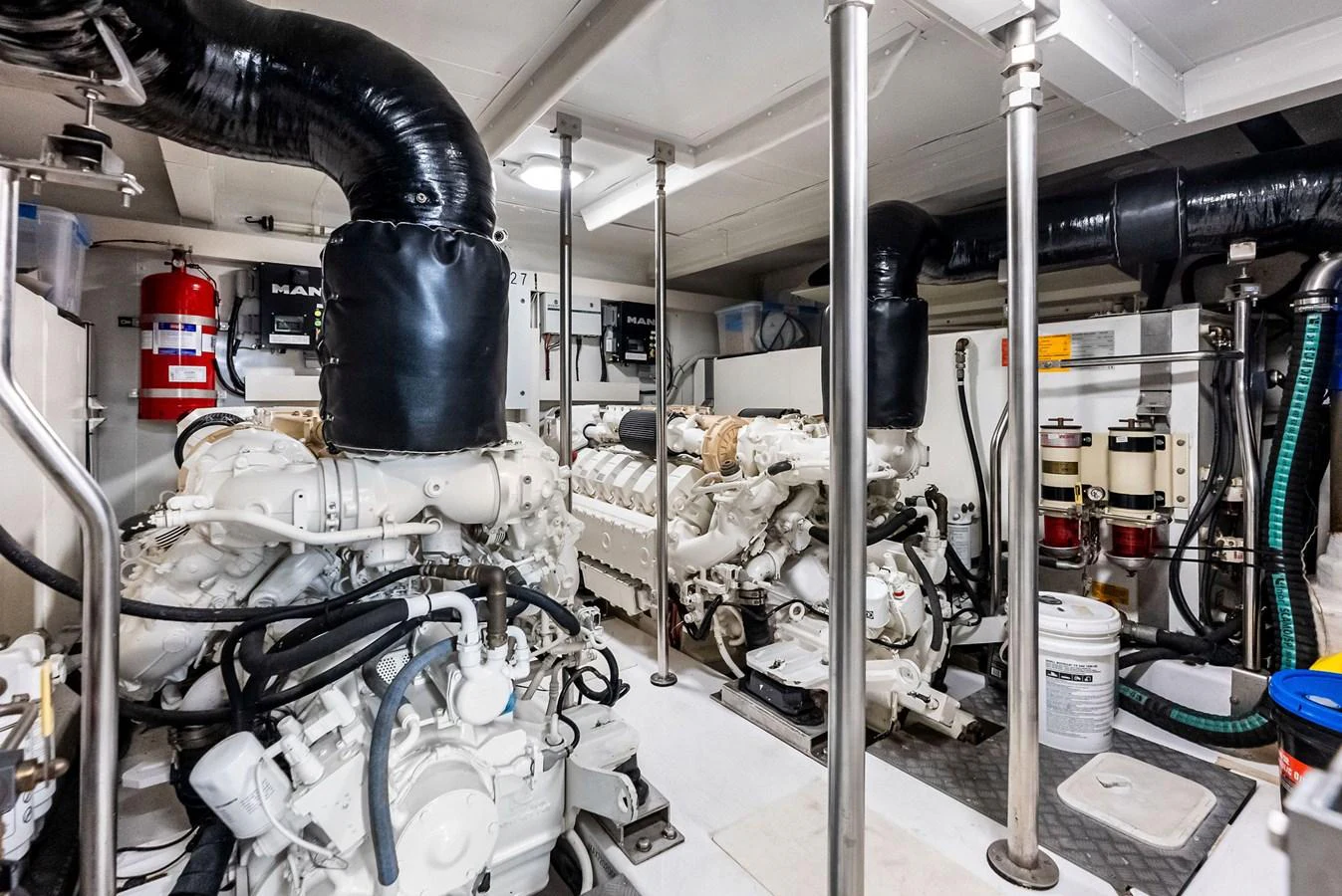 The image showcases a well-maintained engine room with powerful machinery and organized components. aboard CLASS DISMISSED Yacht for Sale