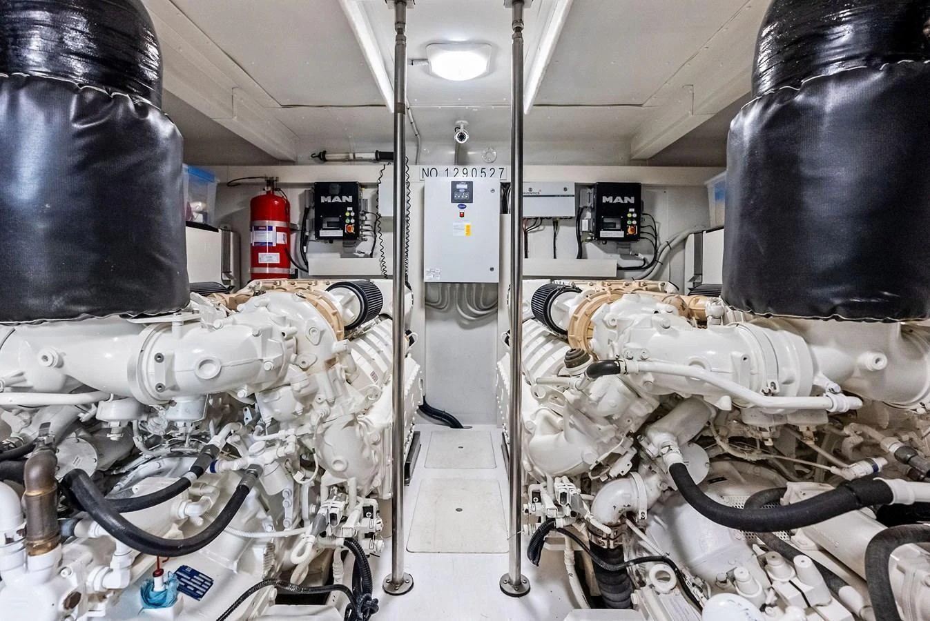 The image showcases the well-maintained engine room of the yacht, featuring powerful MAN engines. aboard CLASS DISMISSED Yacht for Sale