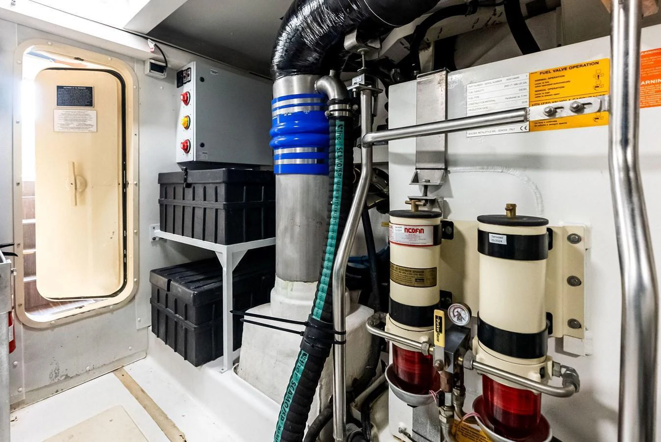 The image showcases the well-maintained engine room with various mechanical components and storage solutions. aboard CLASS DISMISSED Yacht for Sale