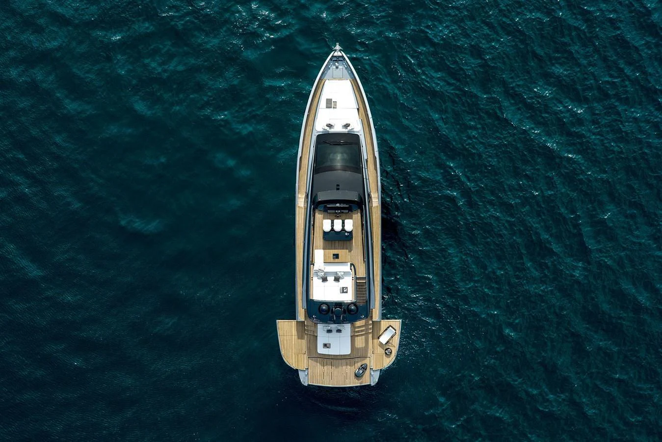 An aerial view of a sleek yacht cruising through deep blue waters. aboard GTX70 Yacht for Sale
