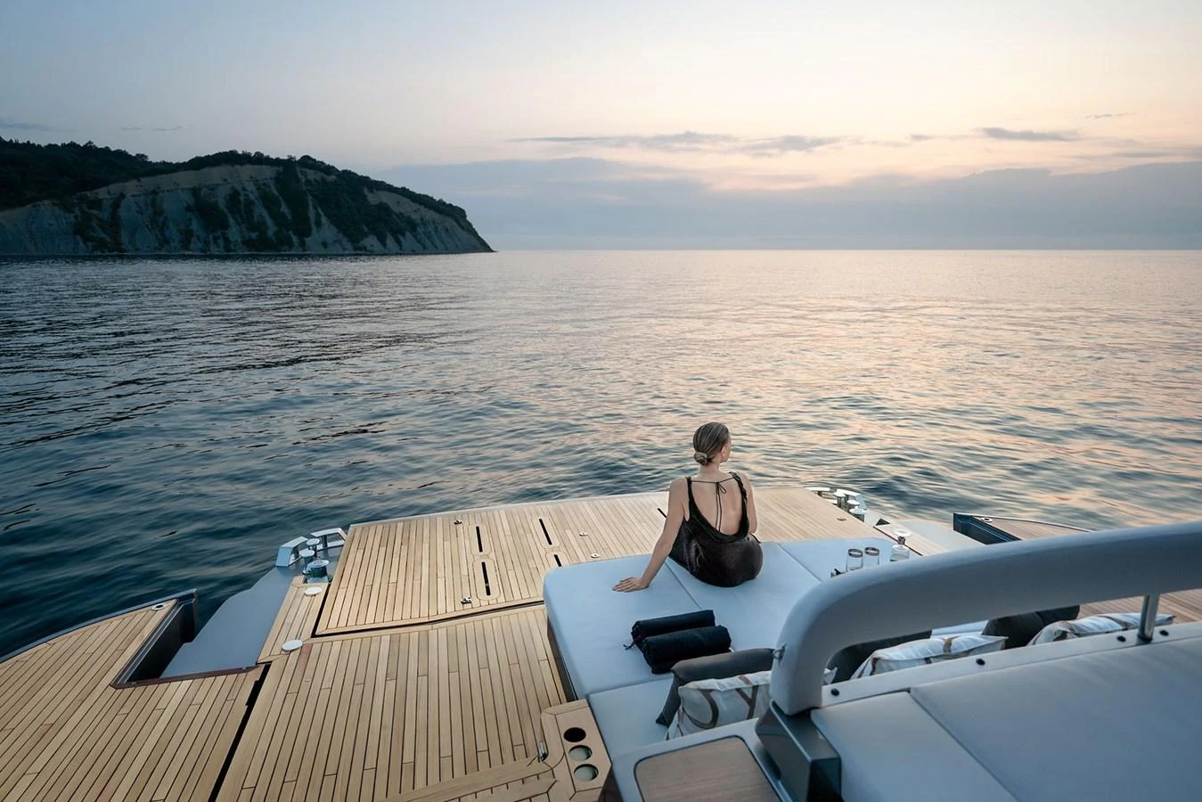A serene aft deck offers a tranquil view of the sea at sunset. aboard GTX70 Yacht for Sale