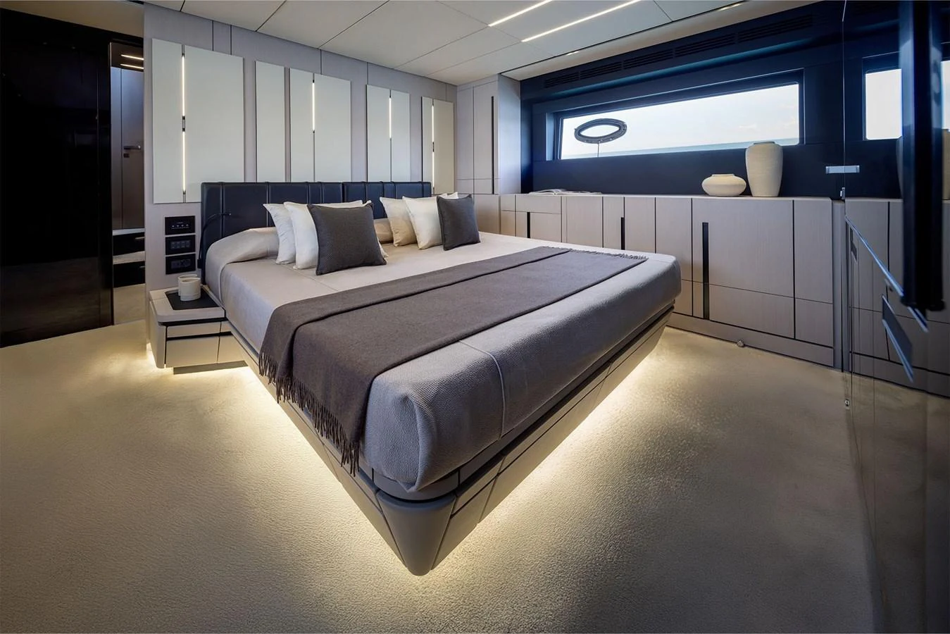 The master stateroom features a luxurious bed with ambient lighting and modern decor. aboard GTX70 Yacht for Sale