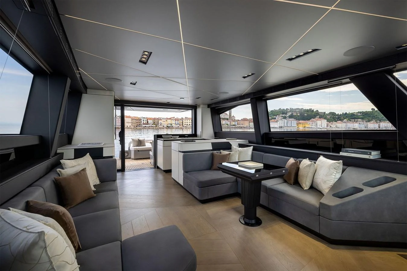 The yacht's salon features modern furnishings and expansive windows offering panoramic views. aboard GTX70 Yacht for Sale