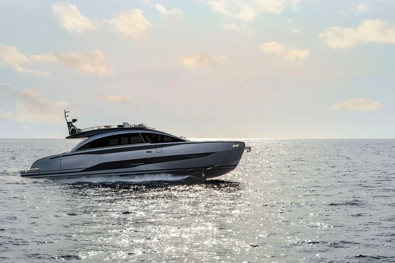 A sleek and modern yacht glides effortlessly across calm waters under a serene sky. aboard GTX70 Yacht for Sale