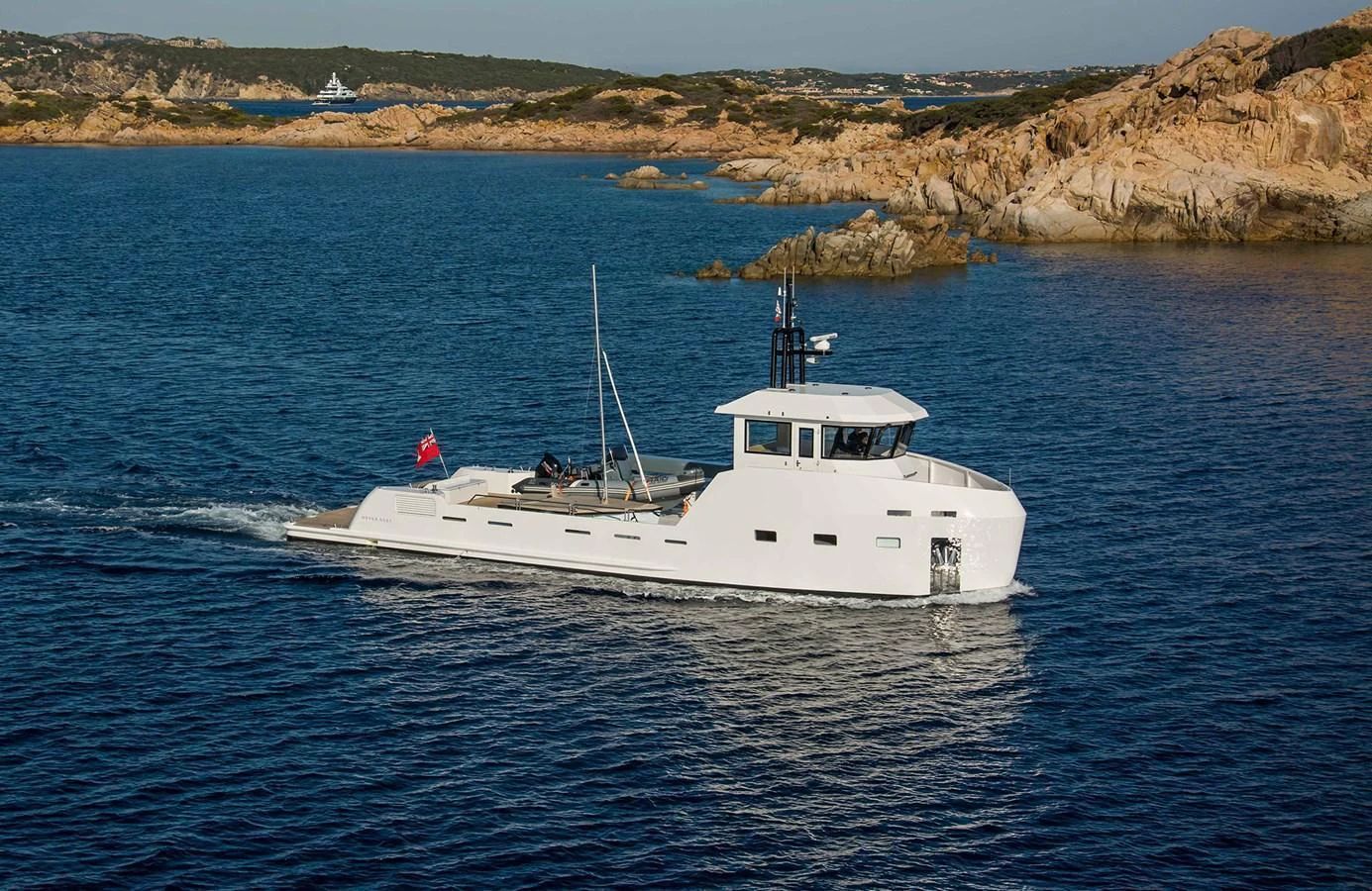 A sleek yacht cruises through calm waters near a rocky coastline. aboard 20 YXT Yacht for Sale