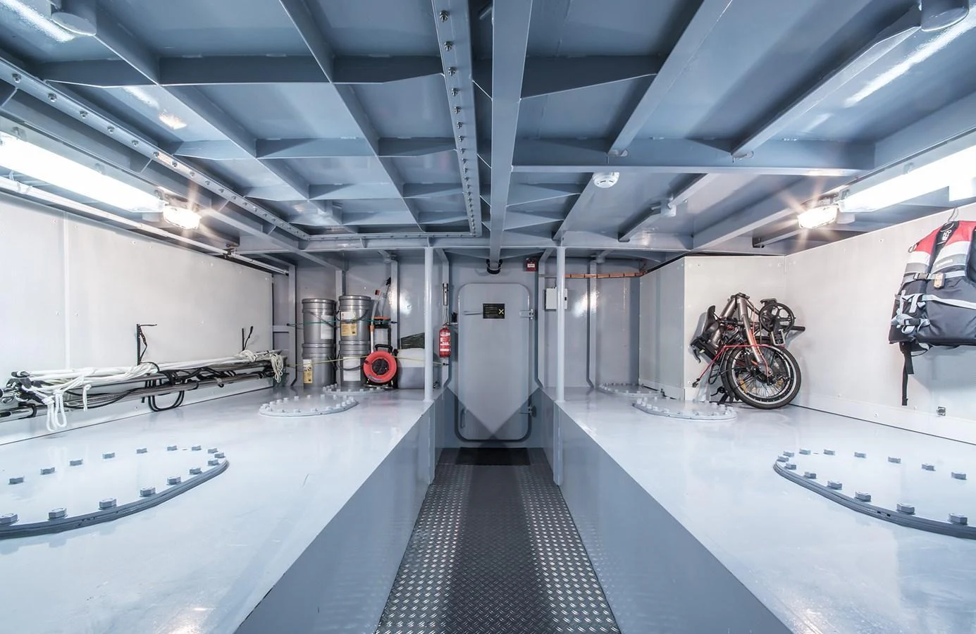 The yacht's interior storage area is spacious and well-organized, featuring equipment and bicycles. aboard 20 YXT Yacht for Sale