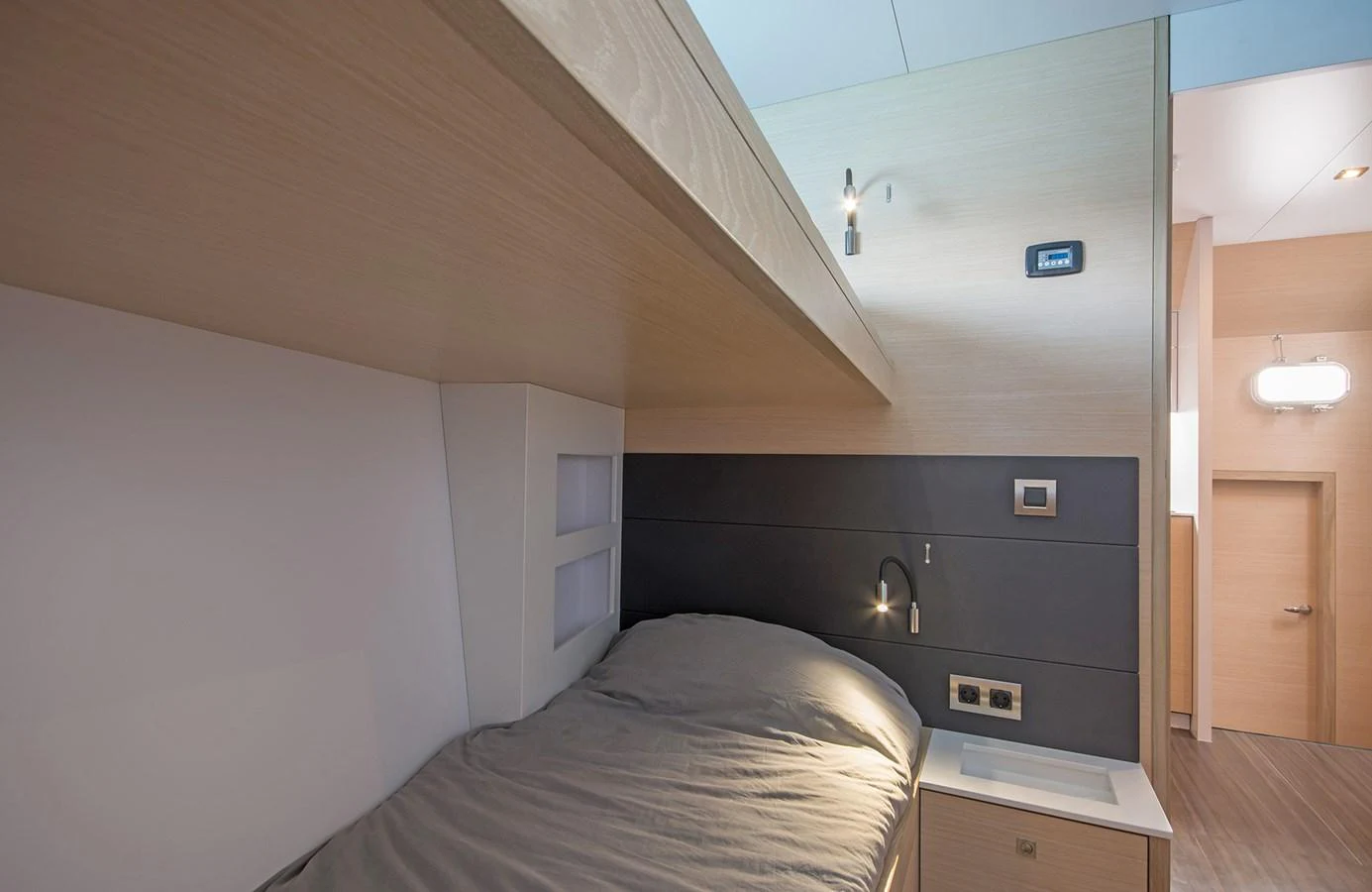 A cozy cabin with a modern design and comfortable bedding. aboard 20 YXT Yacht for Sale