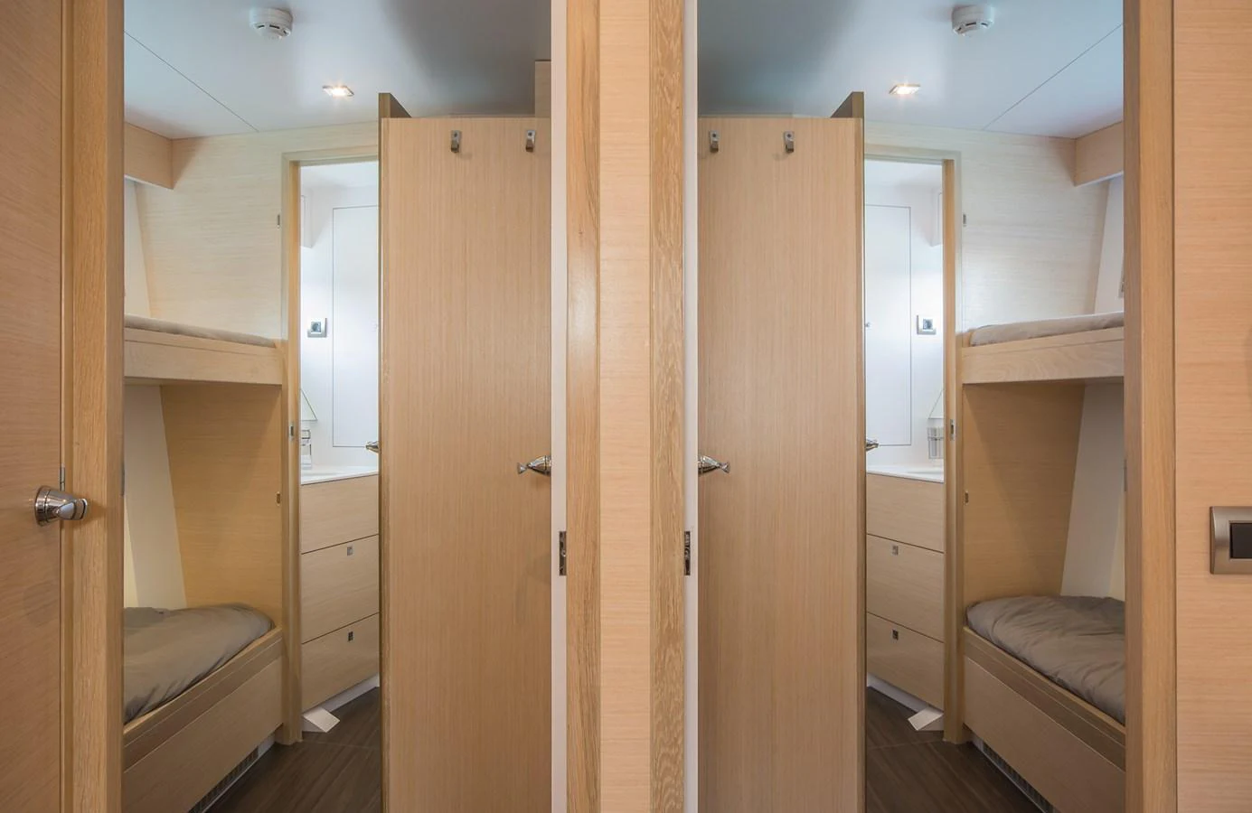 This image showcases a cozy twin cabin with bunk beds and wooden finishes. aboard 20 YXT Yacht for Sale