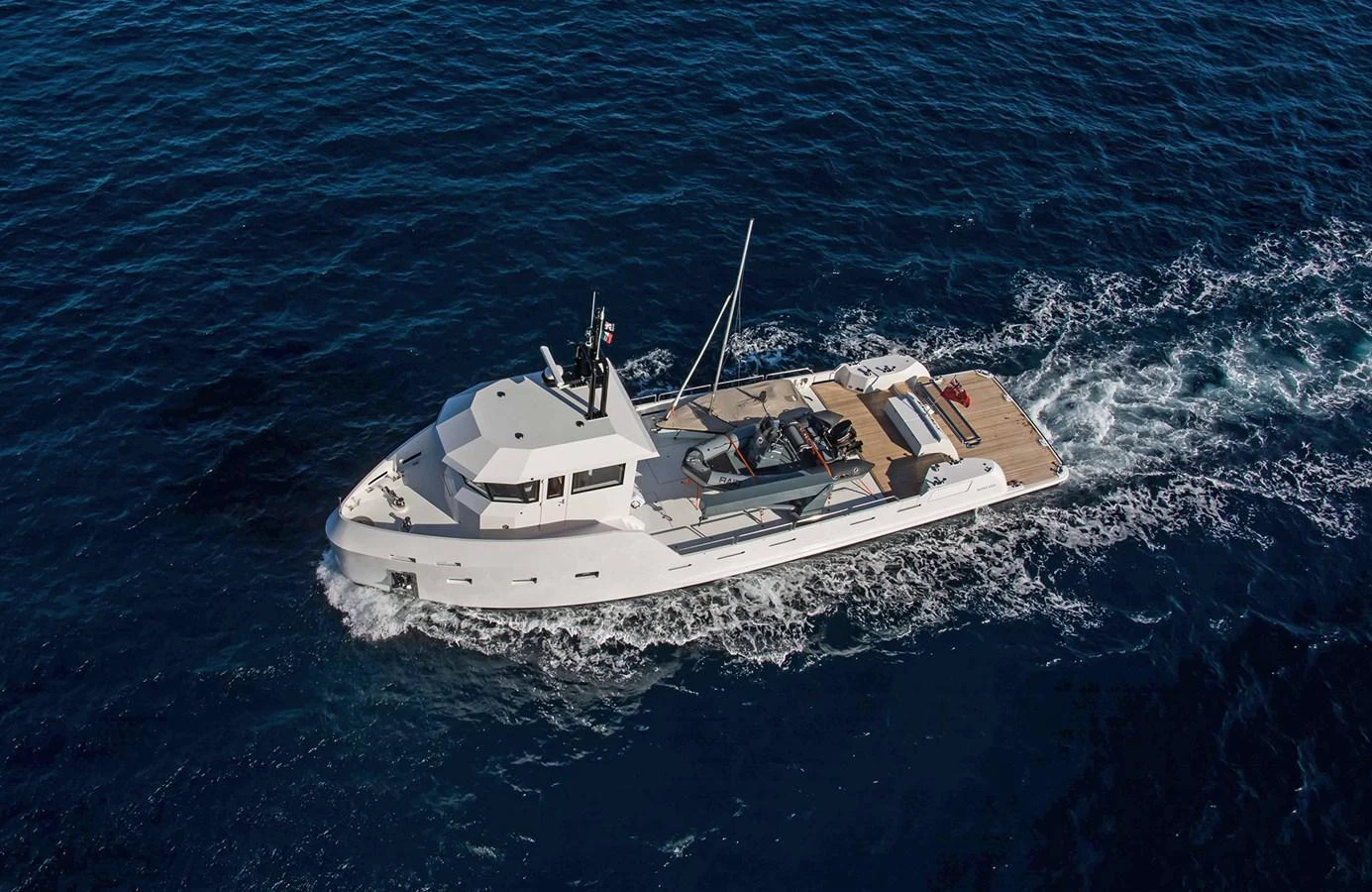 A sleek yacht cruises through deep blue waters, showcasing its modern design and spacious deck. aboard 20 YXT Yacht for Sale