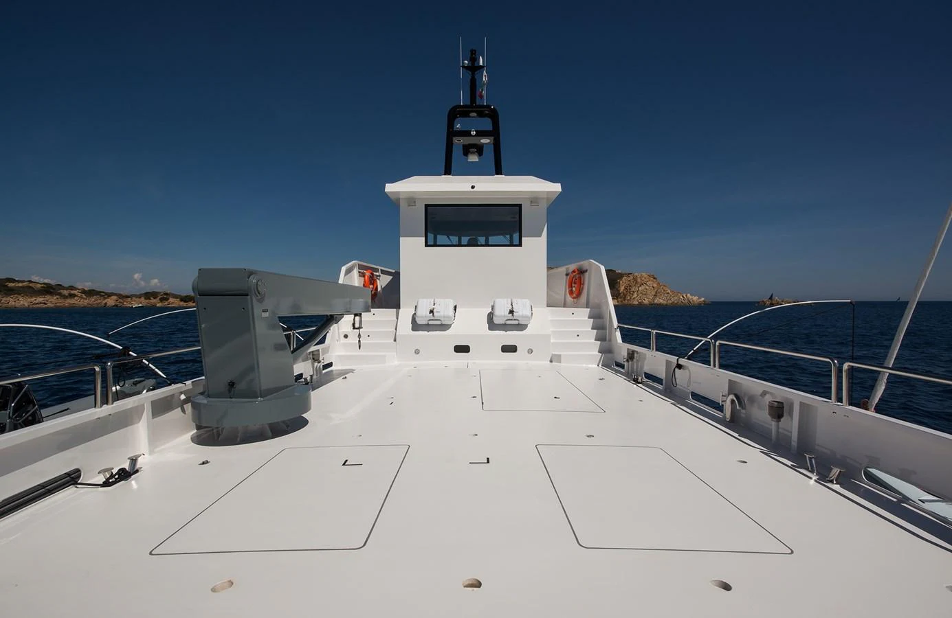 The foredeck offers a spacious and clean area with sun loungers, perfect for relaxation while cruising. aboard 20 YXT Yacht for Sale